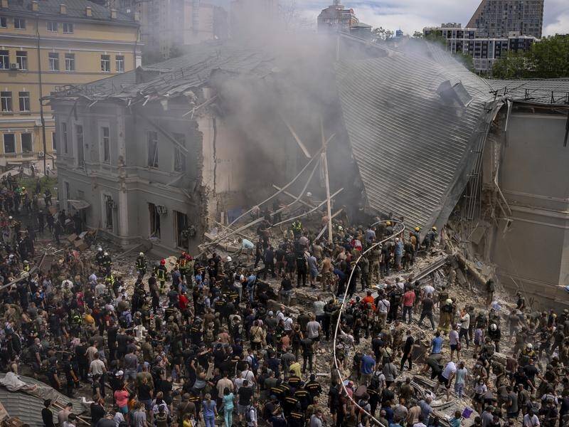 Hundreds of Kyiv residents have helped to clear debris after a hospital was struck by a missile. (AP PHOTO)