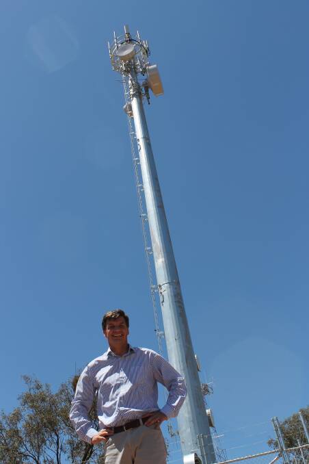 FASTER, BETTER: Member for Hume Angus Taylor with one of the newly installed fixed wireless NBN towers in Cowra 