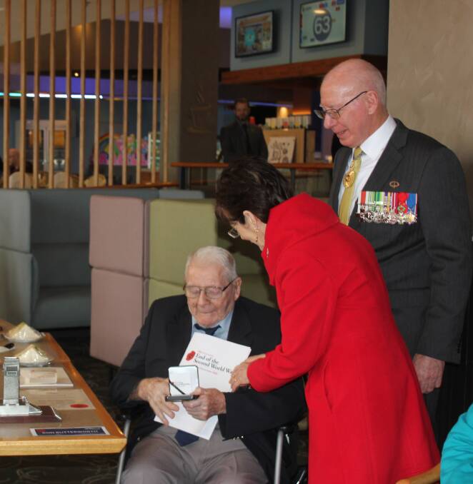 Recognised: His Excellency David Hurley AC DSC (Retd) and wife, Linda presenting Ron Butterworth with the Department of Veterans' Affairs medallions and commemoration certificates. Photo: Burney Wong. 