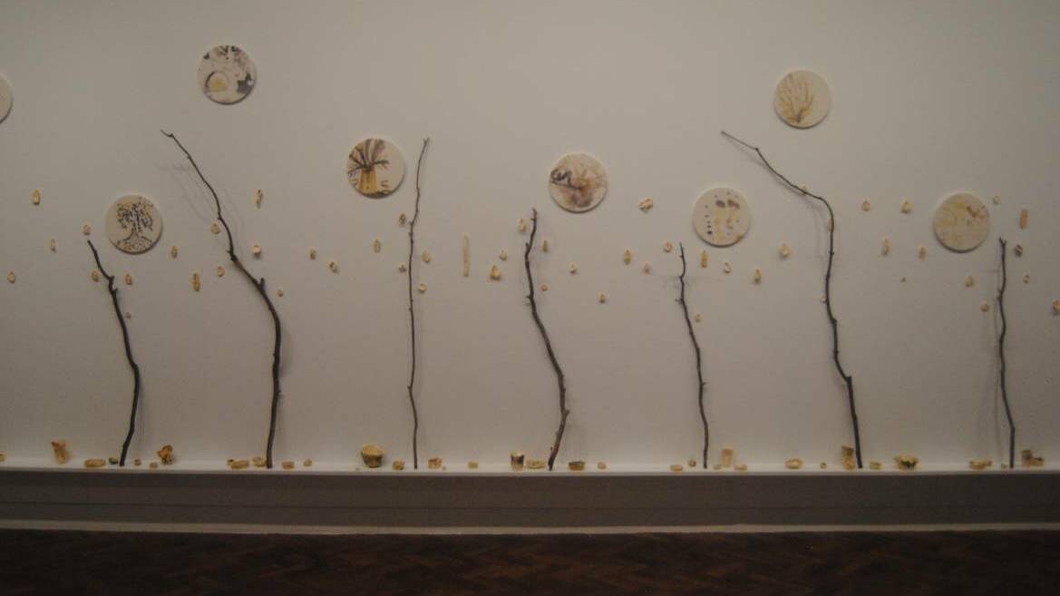 Harriet Body's "We grew up amongst trees 2021" done in collaboration with Yours participants. It uses installations of earthenware ceramics with glaze, dropped eucalyptus branches, eucalyptus dye paintings printed on synthetic stone. 