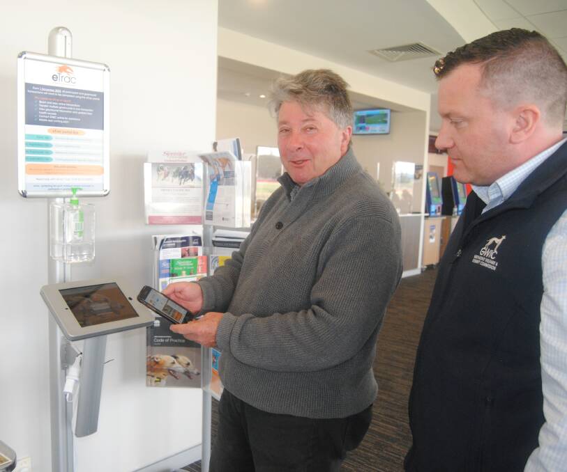 Greyhound Welfare and Integrity Commission director Matthew Tutt teaching Ashley Dwyer how to use eTrac at the Goulburn Greyhound Racing Club. Picture by Burney Wong. 