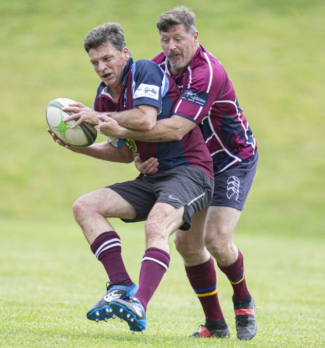 Member for Hume Angus Taylor being tackled in the golden-oldies match. Picture by Pete Oliver. 