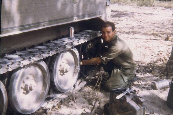 RUNNING REPAIRS: Trooper Bill White undertaking maintenance and repair to an armoured personnel carrier at Fire Support Base ‘Julia’ in south Vietnam in 1968.