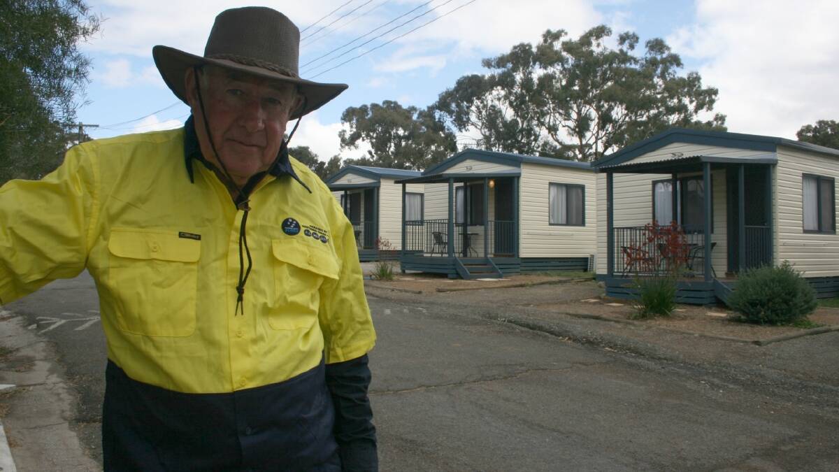   UPGRADE: Interim Goulburn South Caravan Park caretaker Richard Potter with some of the new cabins built for the facility since Southern Cross Parks took over the lease. The park will be put to auction early next year 